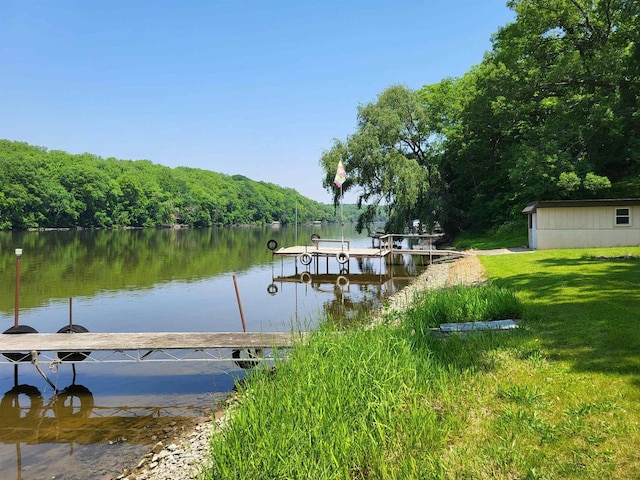 9317 N Arrowhead Shores Rd, Edgerton, WI 53534 - dock area with a water view, a forest view, and a yard