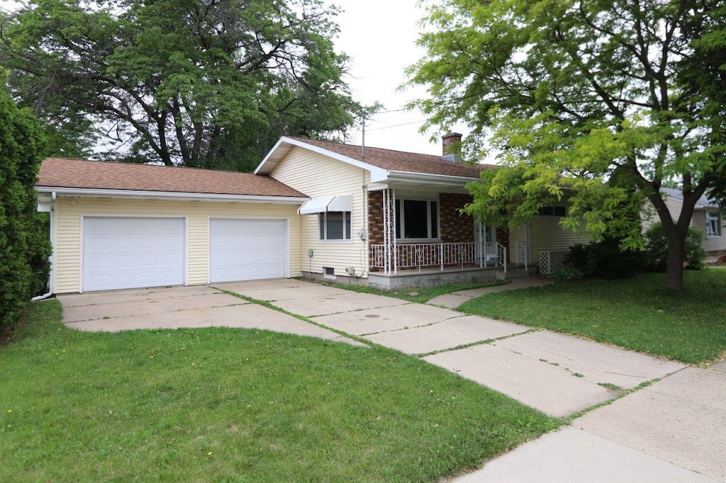 1517 Burdick St, Oshkosh, WI 54901 - ranch-style home with covered porch, a chimney, and a front yard