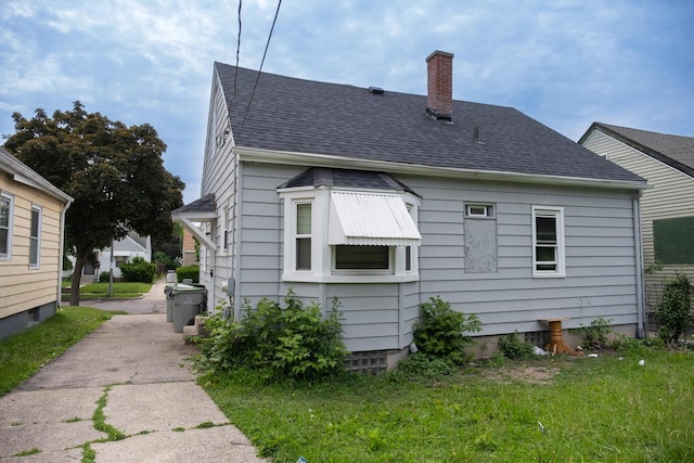 5136 N 42nd St, Milwaukee, WI 53209 - view of home's exterior with a chimney and roof with shingles