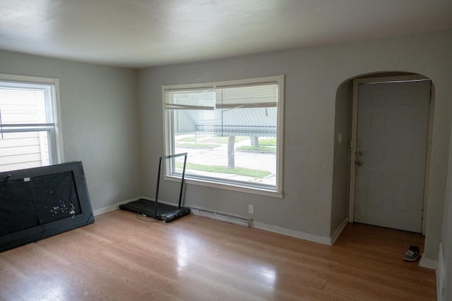 5136 N 42nd St, Milwaukee, WI 53209 - empty room featuring arched walkways, wood finished floors, and healthy amount of natural light