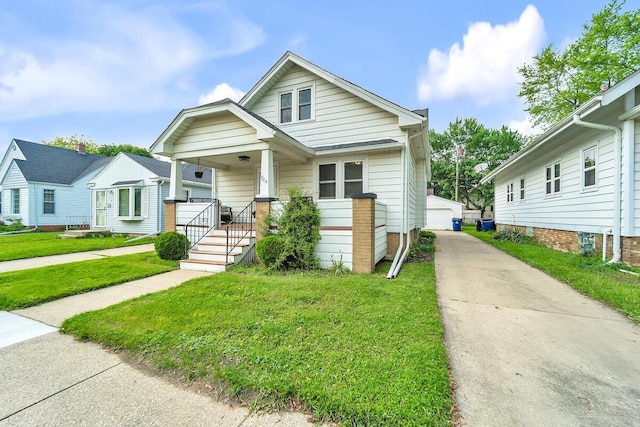 904 Romayne Ave, Racine, WI 53402 - view of front of property with a front lawn, covered porch, an outbuilding, and a detached garage