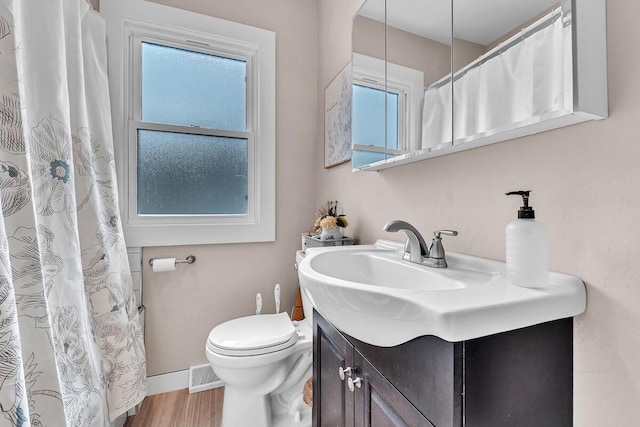 904 Romayne Ave, Racine, WI 53402 - bathroom with vanity, wood finished floors, and curtained shower