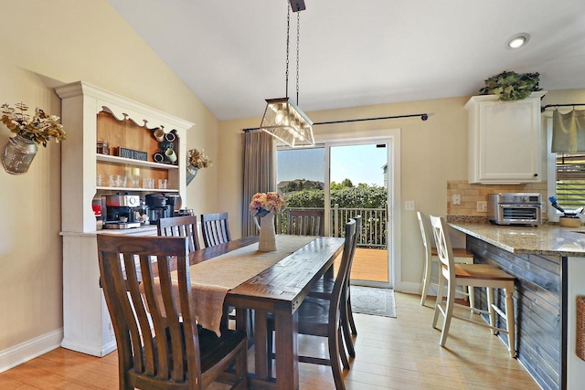 329 S Stone Ridge Dr, Lake Geneva, WI 53147 - dining room featuring light wood finished floors, vaulted ceiling, and recessed lighting