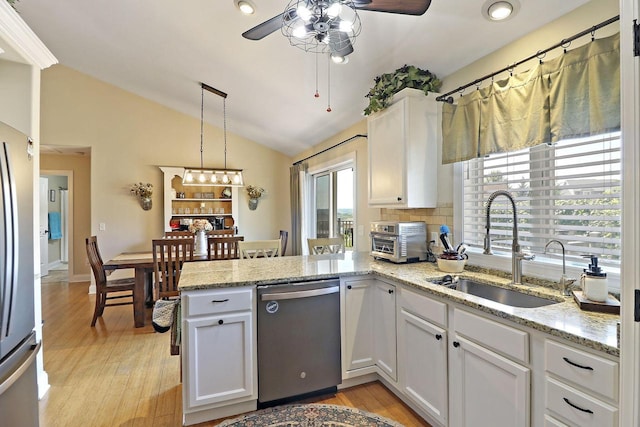 329 S Stone Ridge Dr, Lake Geneva, WI 53147 - kitchen with stainless steel appliances, a ceiling fan, a peninsula, vaulted ceiling, and white cabinets