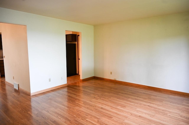 5905-5907 Rattman Rd, Madison, WI 53718 - unfurnished bedroom with wood finished floors and refrigerator