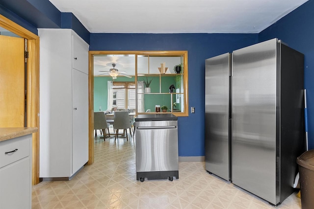 914 W 5th Ave, Oshkosh, WI 54902 - kitchen with freestanding refrigerator, light floors, a ceiling fan, white cabinets, and light countertops