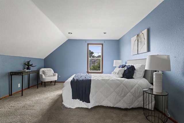914 W 5th Ave, Oshkosh, WI 54902 - carpeted bedroom with lofted ceiling and a textured wall