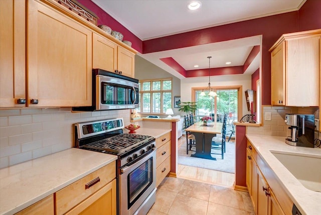 14 Wood Brook Way, Fitchburg, WI 53711 - kitchen with stainless steel appliances, light brown cabinetry, tasteful backsplash, decorative light fixtures, and light tile patterned floors