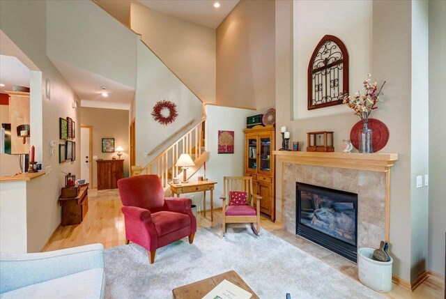 14 Wood Brook Way, Fitchburg, WI 53711 - living room featuring stairs, recessed lighting, a high ceiling, a fireplace, and wood finished floors