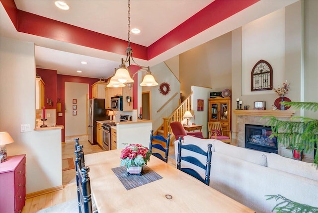 14 Wood Brook Way, Fitchburg, WI 53711 - dining area featuring stairway, recessed lighting, a fireplace, and light wood-style floors