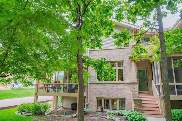 14 Wood Brook Way, Fitchburg, WI 53711 - view of front of property featuring brick siding, stairs, and a deck