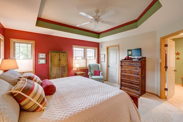 14 Wood Brook Way, Fitchburg, WI 53711 - bedroom featuring multiple windows, light carpet, a tray ceiling, and ceiling fan