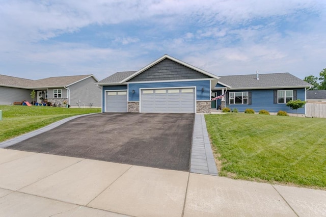 8810 Hinner Springs Dr, Weston, WI 54476 - view of front of home with asphalt driveway, a front lawn, stone siding, and a garage