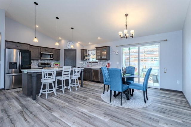 8810 Hinner Springs Dr, Weston, WI 54476 - dining space with lofted ceiling, a chandelier, light wood-type flooring, and recessed lighting