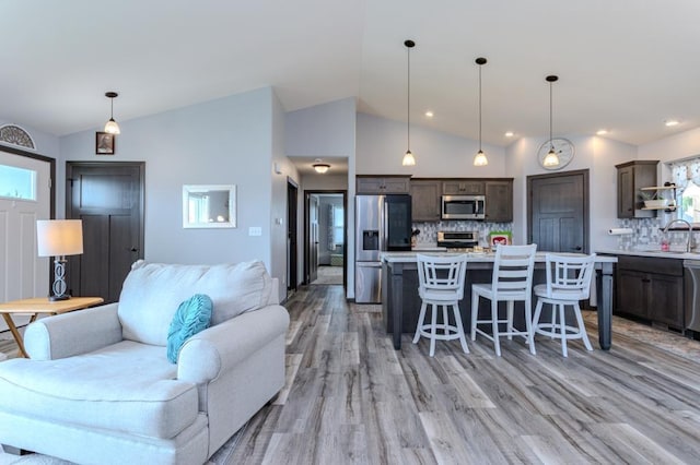 8810 Hinner Springs Dr, Weston, WI 54476 - living area with vaulted ceiling, light wood-style flooring, and recessed lighting
