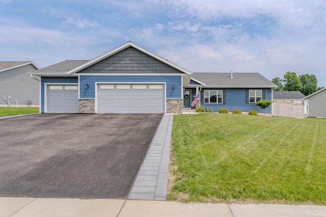 8810 Hinner Springs Dr, Weston, WI 54476 - view of front of property with driveway, stone siding, a front lawn, and a garage