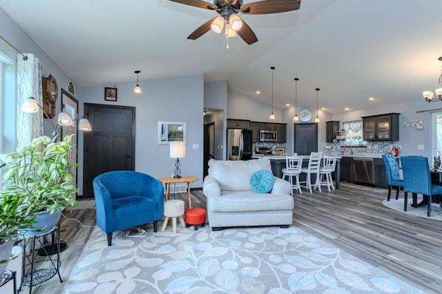 8810 Hinner Springs Dr, Weston, WI 54476 - living room featuring light wood-style flooring, lofted ceiling, a ceiling fan, a chandelier, and recessed lighting
