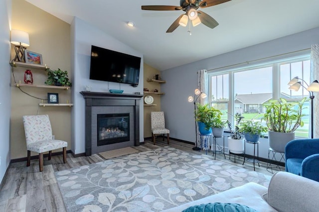 8810 Hinner Springs Dr, Weston, WI 54476 - living room with a fireplace with flush hearth, wood finished floors, vaulted ceiling, and ceiling fan