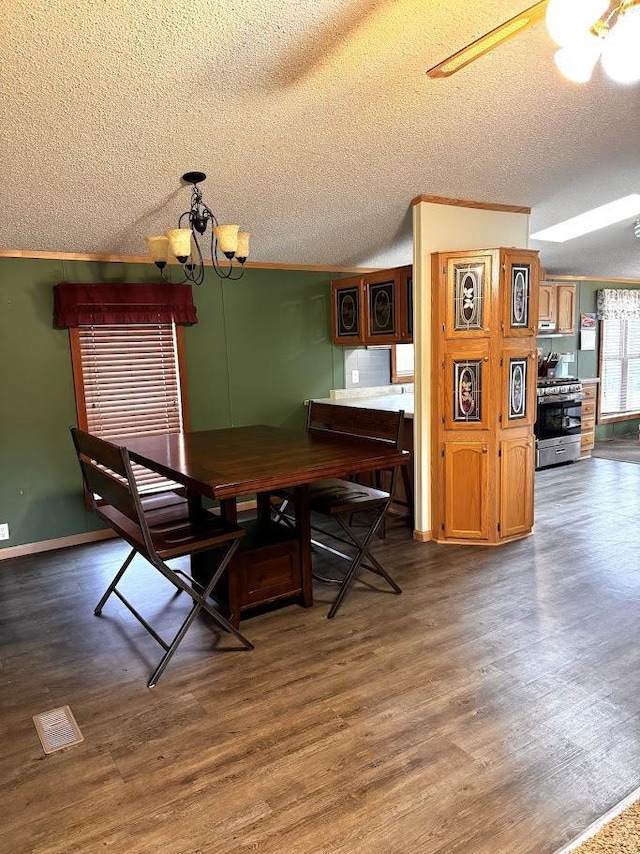 691 Valley Trl, Nekoosa, WI 54457 - dining space with a textured ceiling, ornamental molding, wood finished floors, and a chandelier
