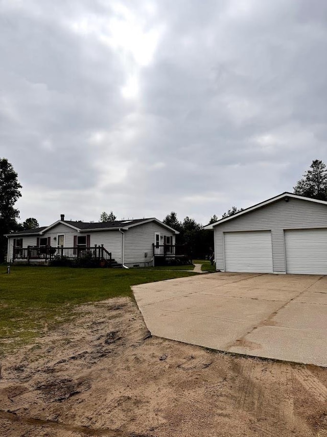 691 Valley Trl, Nekoosa, WI 54457 - exterior space with a deck, an outdoor structure, a yard, and a detached garage