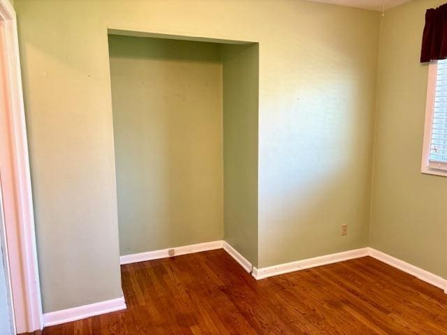 1710 N 25th St, Sheboygan, WI 53081 - empty room featuring dark wood-style flooring and baseboards