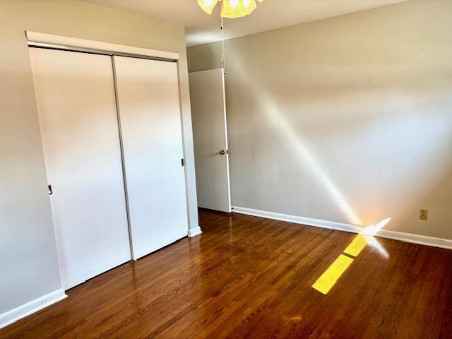 1710 N 25th St, Sheboygan, WI 53081 - unfurnished bedroom featuring wood finished floors, a closet, and ceiling fan