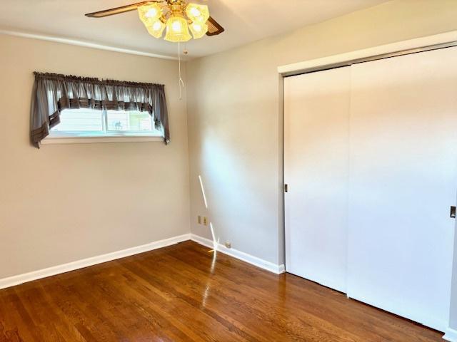 1710 N 25th St, Sheboygan, WI 53081 - unfurnished bedroom featuring wood finished floors, a closet, and ceiling fan