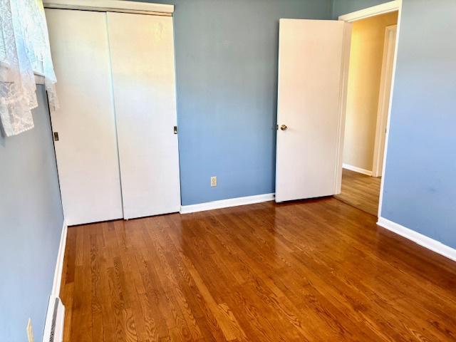 1710 N 25th St, Sheboygan, WI 53081 - unfurnished bedroom with wood finished floors and a closet