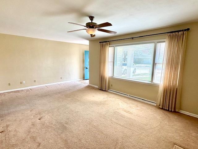 1710 N 25th St, Sheboygan, WI 53081 - empty room with baseboard heating, a ceiling fan, and carpet floors