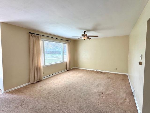 1710 N 25th St, Sheboygan, WI 53081 - carpeted spare room featuring a ceiling fan and a baseboard radiator
