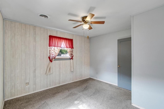 226 Winnebago Ave, Portage, WI 53901 - carpeted empty room featuring ceiling fan and wood walls