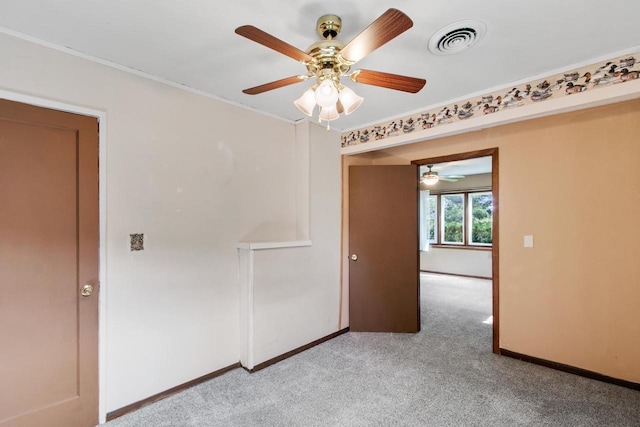 226 Winnebago Ave, Portage, WI 53901 - unfurnished room with light colored carpet, a ceiling fan, and ornamental molding