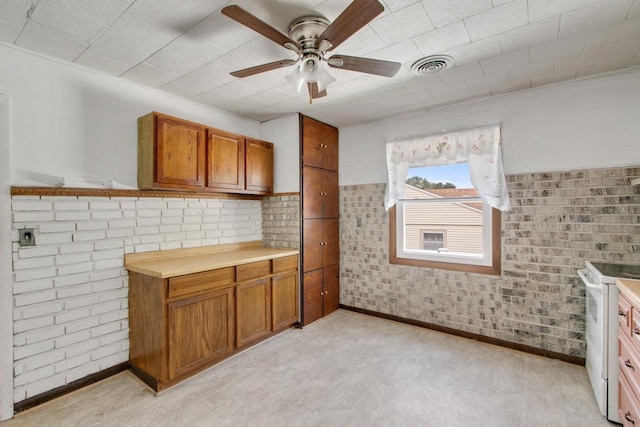 226 Winnebago Ave, Portage, WI 53901 - kitchen with brown cabinetry, a ceiling fan, and light countertops
