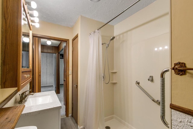 226 Winnebago Ave, Portage, WI 53901 - bathroom featuring a stall shower, vanity, and a textured ceiling
