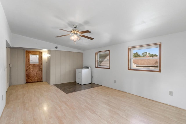 226 Winnebago Ave, Portage, WI 53901 - empty room featuring washer / dryer, wood finished floors, a ceiling fan, and vaulted ceiling