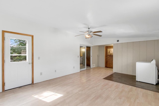 226 Winnebago Ave, Portage, WI 53901 - unfurnished living room featuring light wood-style flooring, washer / clothes dryer, ceiling fan, and vaulted ceiling