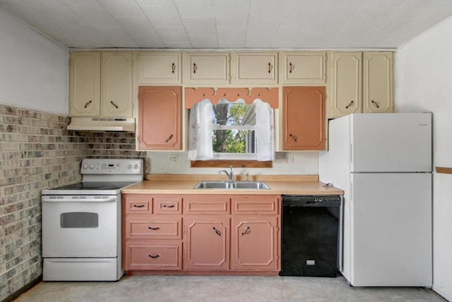 226 Winnebago Ave, Portage, WI 53901 - kitchen with white appliances, under cabinet range hood, light countertops, and cream cabinetry