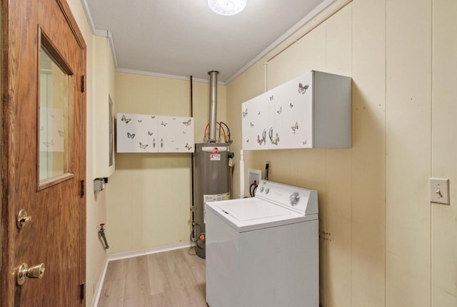 226 Winnebago Ave, Portage, WI 53901 - laundry area featuring cabinet space, washer / dryer, water heater, light wood-type flooring, and ornamental molding
