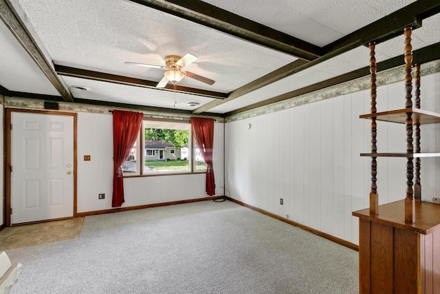 226 Winnebago Ave, Portage, WI 53901 - unfurnished room featuring carpet floors, a ceiling fan, beam ceiling, and a textured ceiling