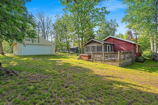 N11134 Nelson Rd, Athelstane, WI 54104 - view of green lawn with a sunroom, a garage, an outbuilding, and a deck