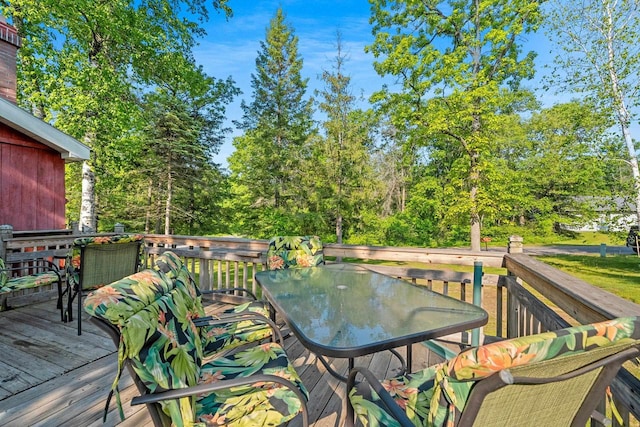 N11134 Nelson Rd, Athelstane, WI 54104 - wooden deck with outdoor dining space and view of scattered trees