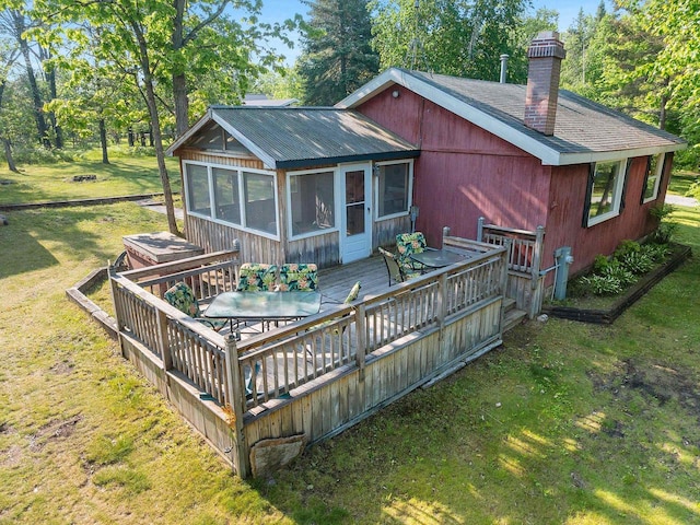 N11134 Nelson Rd, Athelstane, WI 54104 - rear view of property with a deck, a sunroom, a chimney, a lawn, and outdoor dining area