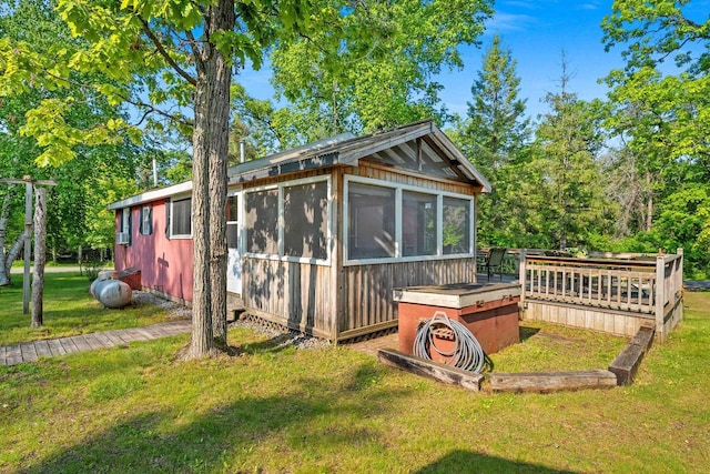 N11134 Nelson Rd, Athelstane, WI 54104 - view of side of home featuring a yard, a wooden deck, and view of wooded area