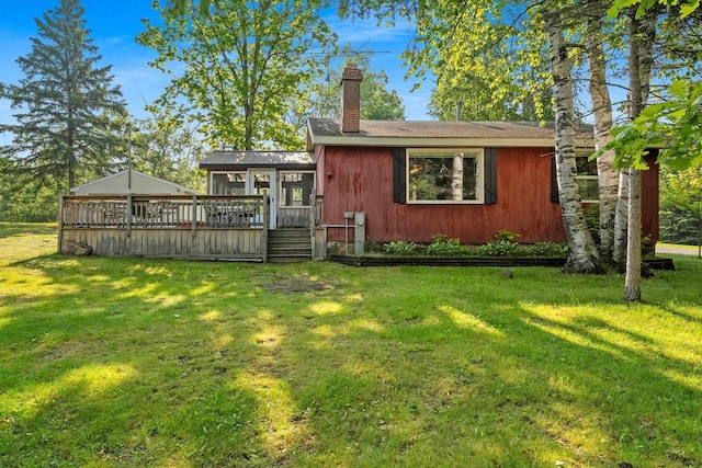 N11134 Nelson Rd, Athelstane, WI 54104 - rear view of property featuring a deck, a lawn, and a chimney