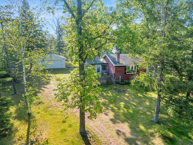 N11134 Nelson Rd, Athelstane, WI 54104 - view of green lawn featuring an outdoor structure and a garage