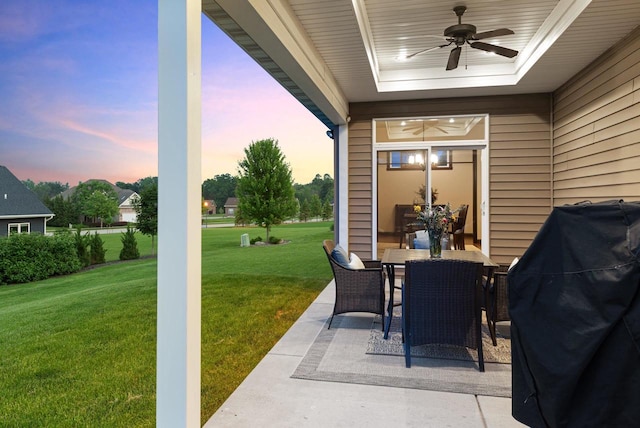 6600 N Kurey Dr, Appleton, WI 54913 - patio terrace at dusk featuring a patio, a ceiling fan, a yard, outdoor dining area, and area for grilling