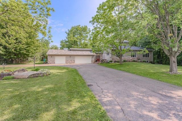 1340 Deer Brook Ct, Wausau, WI 54401 - view of front of house with asphalt driveway, a front lawn, and a garage