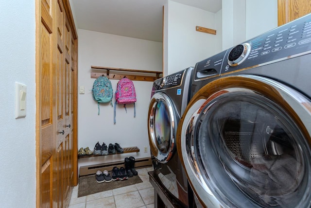 1340 Deer Brook Ct, Wausau, WI 54401 - laundry area featuring washing machine and clothes dryer, a baseboard heating unit, and light tile patterned floors