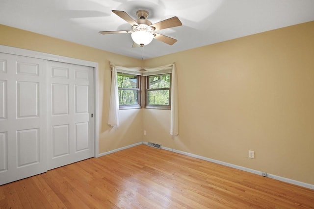 8074 48th Ave, Kenosha, WI 53142 - unfurnished bedroom with light wood-type flooring, a closet, and a ceiling fan