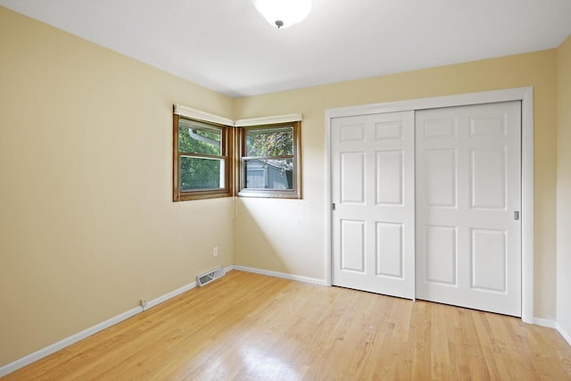 8074 48th Ave, Kenosha, WI 53142 - unfurnished bedroom featuring light wood-style floors and a closet